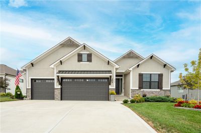 Craftsman-style home with a garage and a front lawn | Image 1