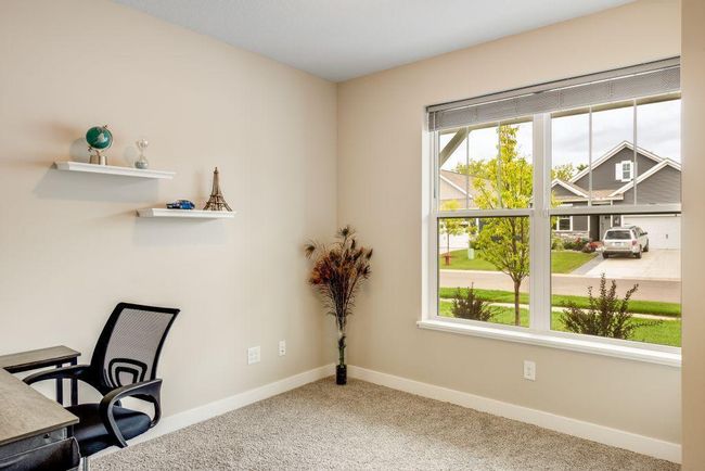 The second bedroom is located on the main floor and currently used as an office. | Image 12