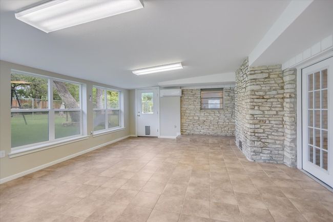 This heated and air conditioned sun porch can be used as a game room, yoga studio, office or entertaining area. | Image 21