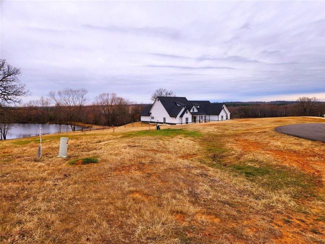 This what the left side view of the neighboring lot and pond view look like. | Image 14