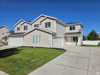 View of front property featuring a front lawn and a garage | Image 1