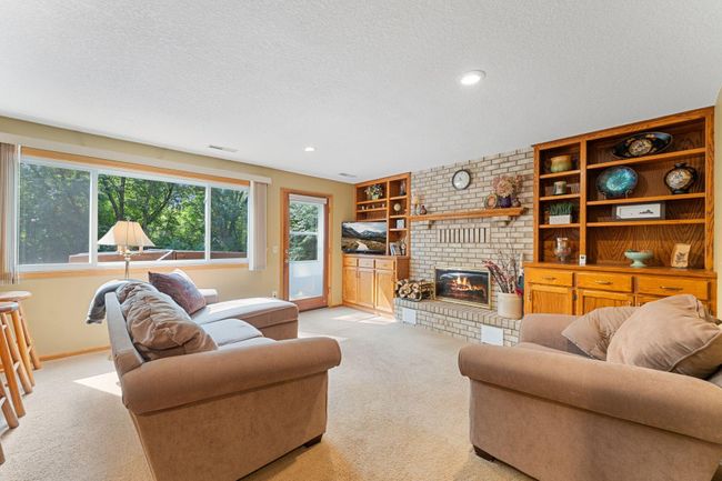 Enjoy the large family room, fire place with custom built ins, and walk-out to the patio with hot tub. | Image 23