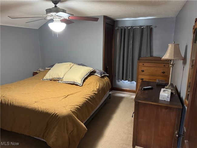 Carpeted bedroom with ceiling fan | Image 12
