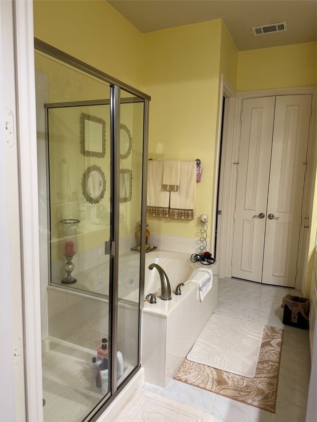 Bathroom with a bath, a shower stall, and tile patterned floors | Image 22