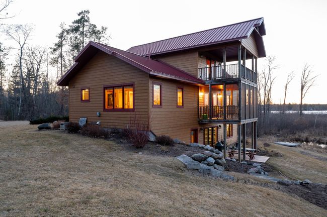The main level screen porch offers outdoor comfort and and go to the upper deck for amazing lake views and sunsets. | Image 8