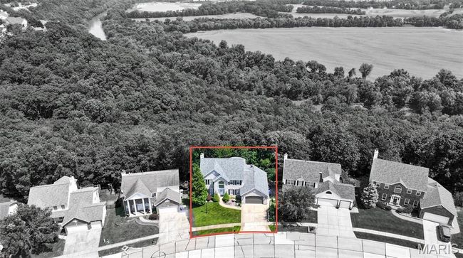 Aerial view of residential area featuring a heavily wooded area and property parcel outlined | Image 60