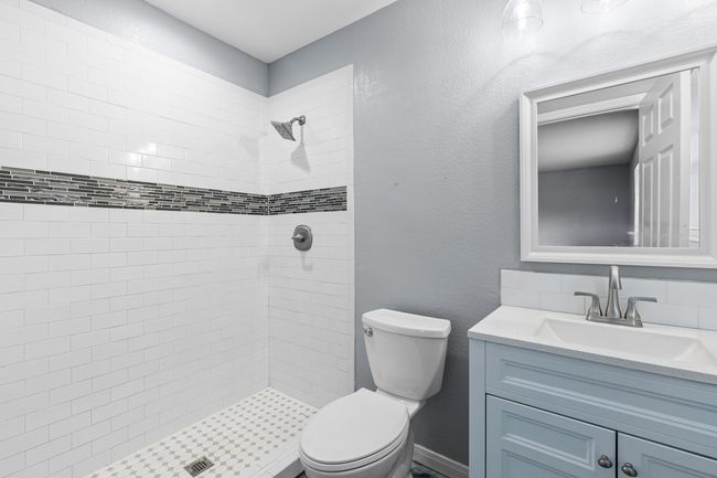 Bathroom featuring tiled shower and vanity | Image 31