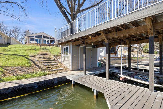 View of dock with a lawn, a water view, and boat lift | Image 23