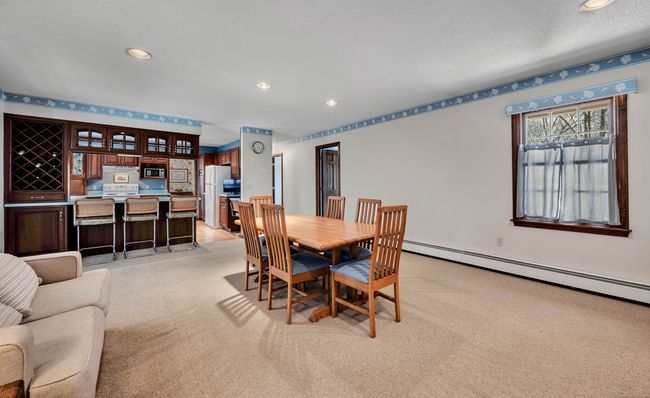 View to kitchen from family room with two additional multipurpose rooms on right | Image 12