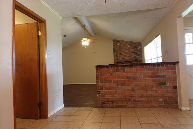 Inviting bar and living area, perfect for entertaining, as seen from the formal dining room. | Image 17