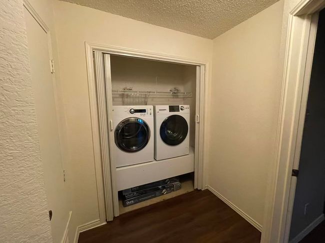 Laundry area featuring washer and clothes dryer, a textured ceiling, and dark wood-type flooring | Image 17
