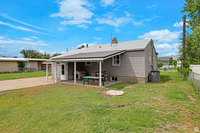 Rear view of house featuring a patio, central AC unit, and a chimney | Image 28