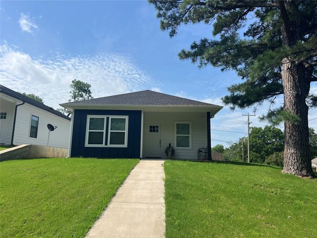View of front facade featuring a front yard, board and batten siding, and roof with shingles | Image 17