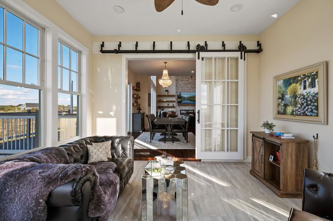 Enjoy peaceful views and access to the side deck for serene outdoor living. | Image 10
