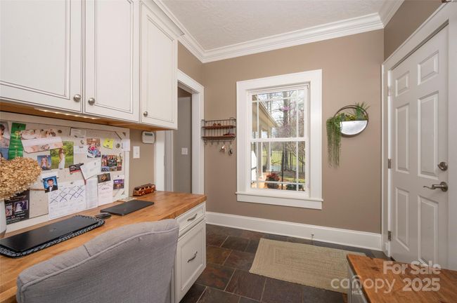 Built-in Desk in Laundry Room has filing cabinet drawer. | Image 17