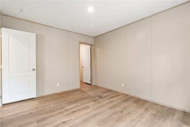 Empty room featuring crown molding, recessed lighting, visible vents, and light wood-type flooring | Image 19