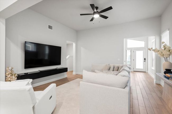 Living area featuring light wood-type flooring and ceiling fan | Image 9