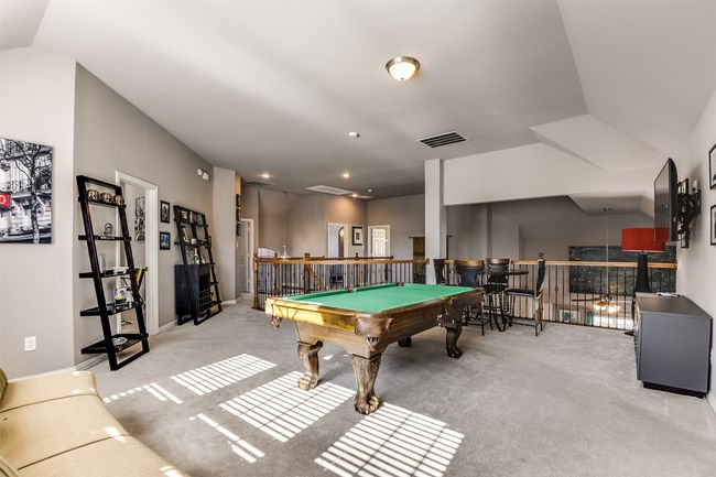 Game room with carpet flooring, lofted ceiling, and pool table | Image 34
