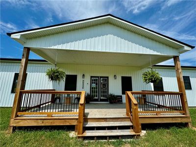 Rear view of house with a wooden deck | Image 2