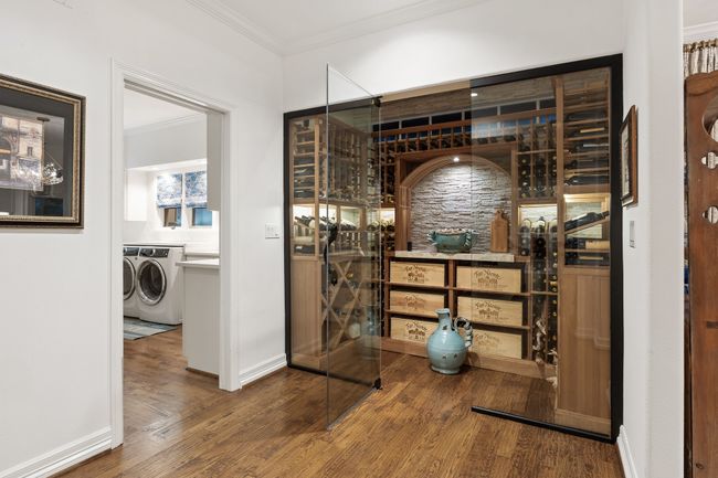 Elegant glass-walled climate controlled wine celler | Image 12
