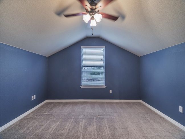 Bonus room with a ceiling fan, lofted ceiling, carpet floors, a textured ceiling, and baseboards | Image 34