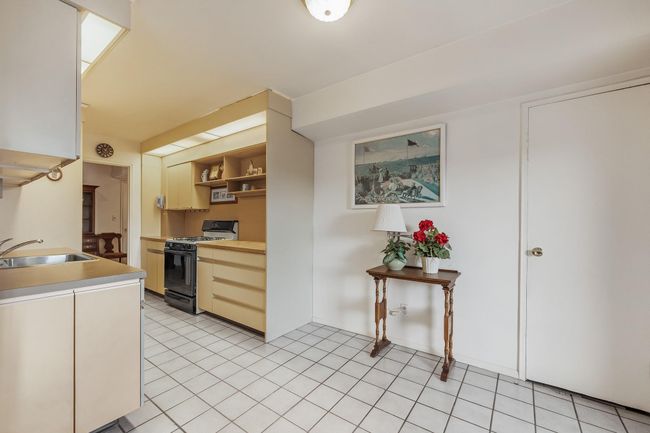 View of kitchen from living room with space for table/chairs | Image 17