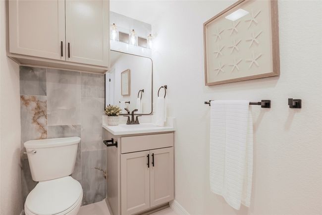 Half bath with vanity and tile walls | Image 17