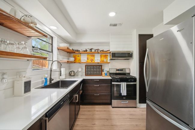 Awesome updated kitchen w/quartz counters, open shelving and stainless appliances. | Image 7