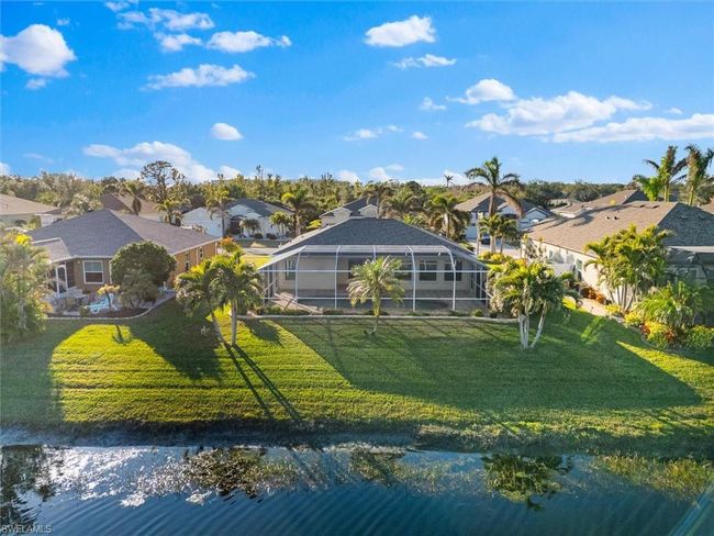 Back of property featuring a lawn and a residential view | Image 33