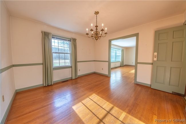 Spare room featuring a chandelier and light hardwood / wood-style floors | Image 16