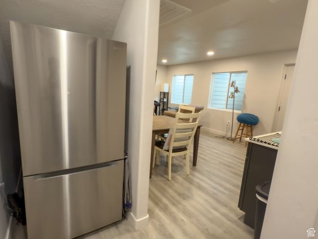 Kitchen featuring freestanding refrigerator, light wood-style flooring, and recessed lighting | Image 20