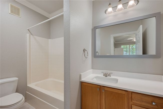 Bathroom featuring vanity and tub / shower combination | Image 8
