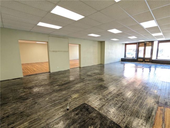 Unfurnished room with a paneled ceiling and hardwood / wood-style floors | Image 4
