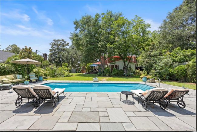 Outdoor pool with a yard and a patio | Image 8