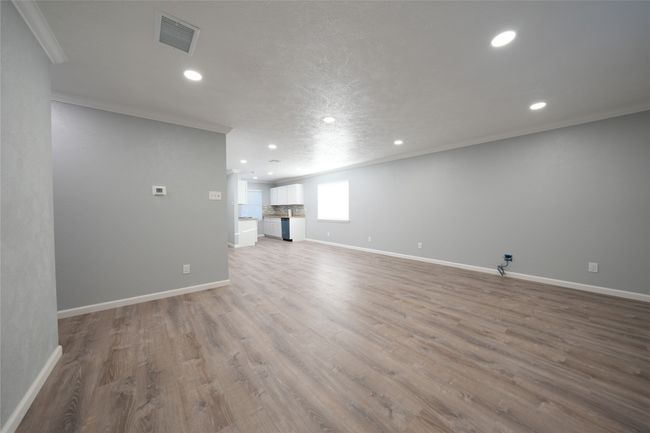 Unfurnished living room featuring visible vents, recessed lighting, ornamental molding, and baseboards | Image 6