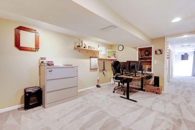 Bedroom 5/office in lower level with large window and access to walkout. | Image 39