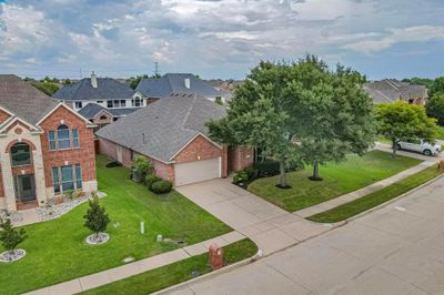 View of front of house featuring a garage, central AC unit, and a front lawn | Image 2