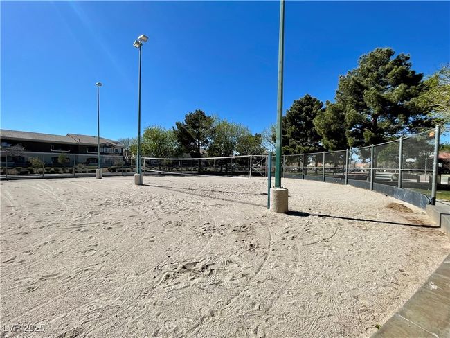View of home's community featuring fence and volleyball court | Image 56