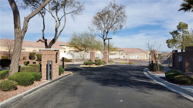 View of street featuring a gate, a gated entry, curbs, and a residential view | Image 24