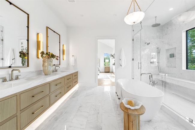 With a beautiful touch, this walk in, double shower features a full bench and rain shower heads to create a relaxing, spa like experience. | Image 40