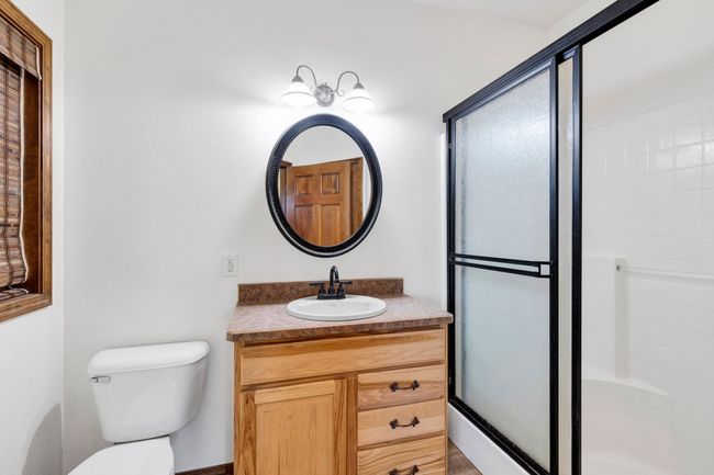 Bathroom featuring vanity, toilet, and an enclosed shower | Image 28