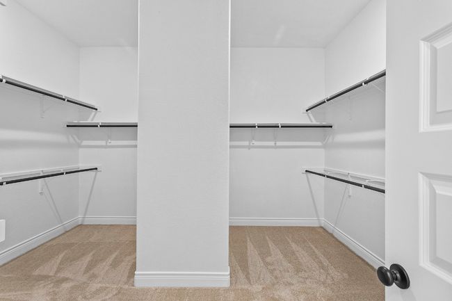 Spacious closet with light carpet | Image 16