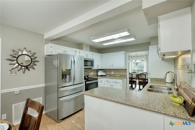 Kitchen with granite counters and stainless appliances | Image 9