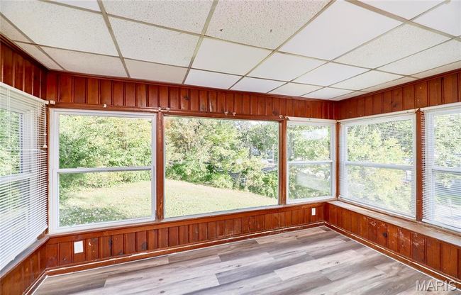 Unfurnished sunroom with a drop ceiling and plenty of natural light | Image 8