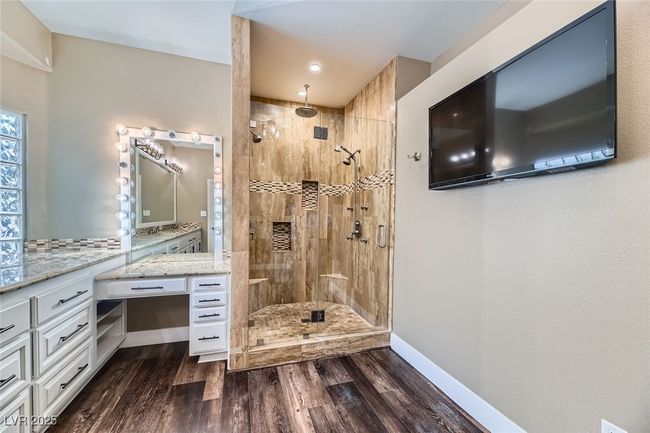 Bathroom featuring a shower stall, wood finished floors, and vanity | Image 22