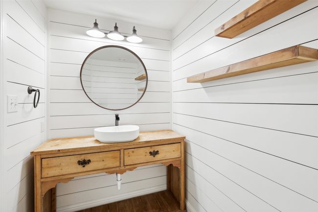 Bathroom with wood walls, hardwood / wood-style floors, and vanity | Image 35