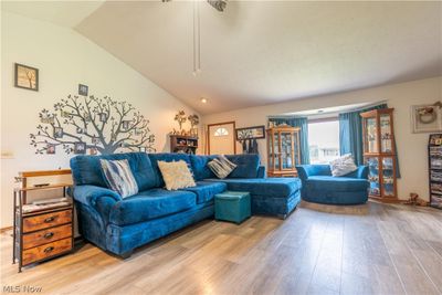 Living room with lofted ceiling and light hardwood / wood-style flooring | Image 3