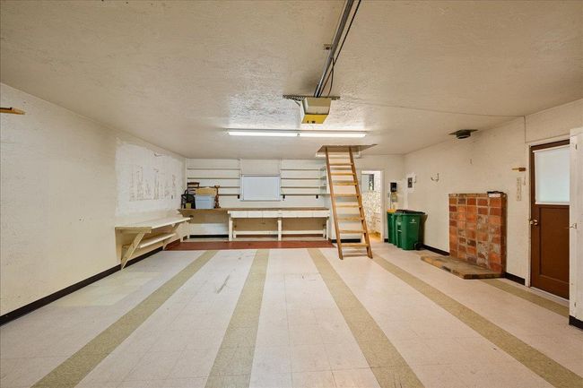 Interior of upper garage with attic and half bath | Image 77