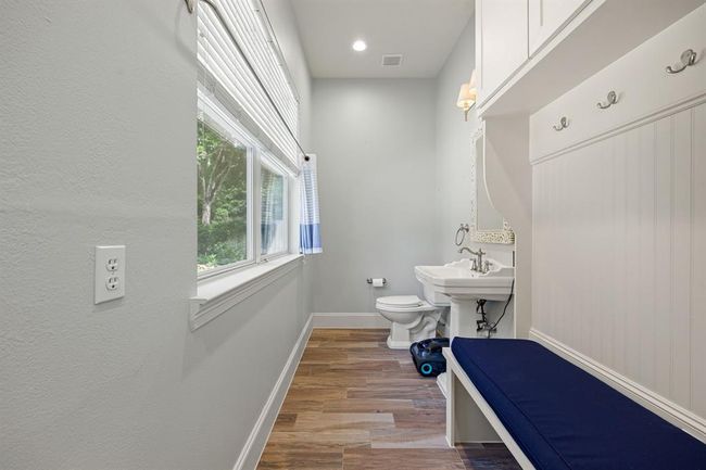Outdoor bathroom near the pool. Utilize this mud space for guests to put their belongings when they are enjoying the backyard pool and spa. | Image 42