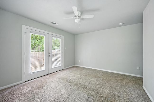 Empty room featuring french doors, carpet, and a ceiling fan | Image 12